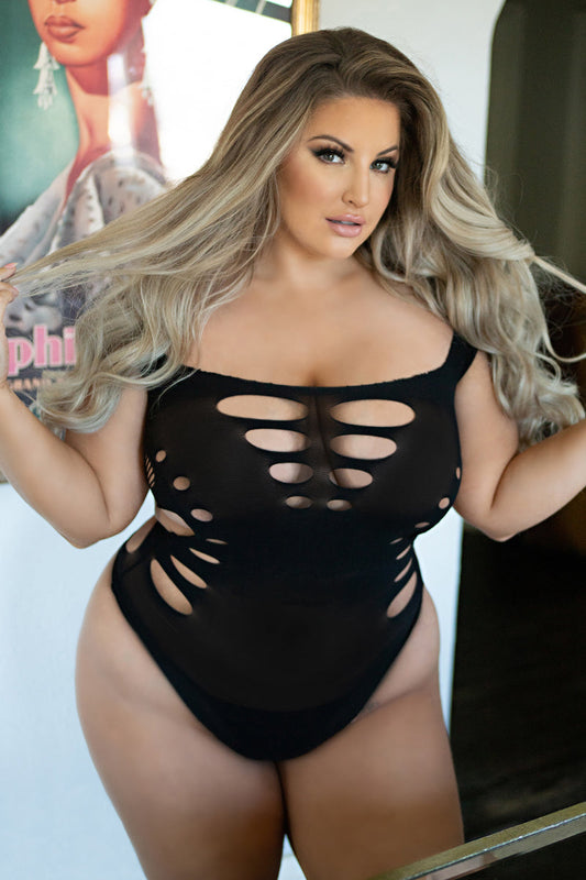 woman wearing a black fishnet mesh bodysuit and thong cut bottom